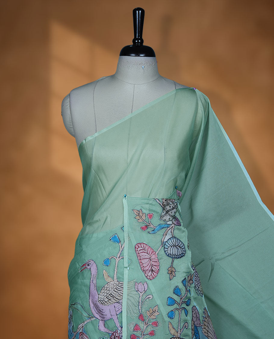 Mint green colour organza saree with multicolour thread embroidery on the pallu and fine border detailing, paired with a matching blouse.