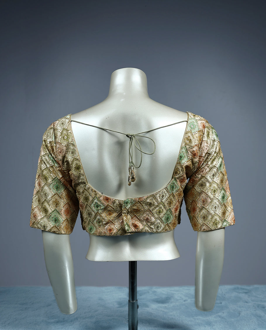 Pastel brocade padded readymade blouse featuring a diamond shaped multicolor weave in soft tones of sage green, peach, and gold, finished with elbow length sleeves and a flattering V neckline