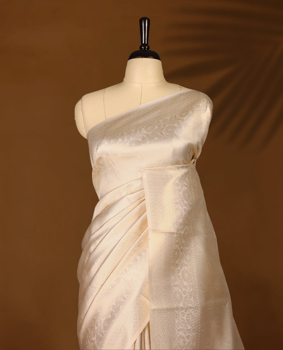 Muted gold Colour soft tissue Kerala saree featuring selfcolour flower motifs on body, Floral kodi designed border, paired with a matching blouse.