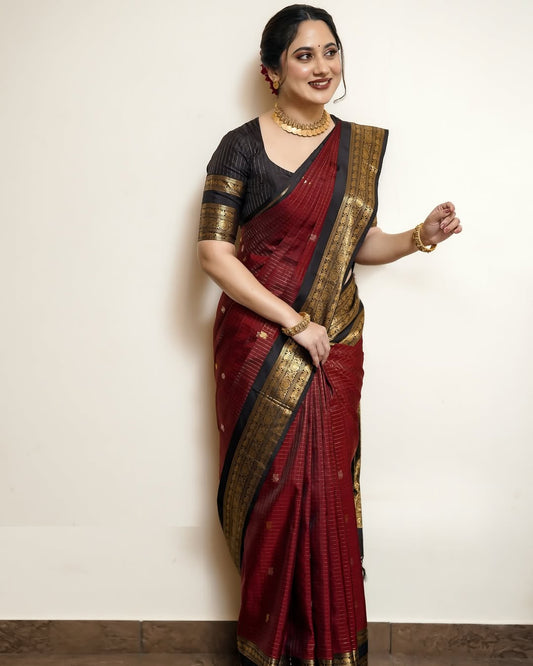 Elegant black and maroon pure Kancheepuram silk saree featuring gold zari elephant & floral brocade border rich maroon body with gold checkered patterns and Gold & Silver colour Peacock Motifs, traditional pallu paired with matching blouse