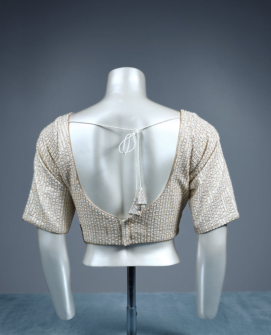 Champagne beige designer padded readymad blouse embellished with vertical sequin lines, featuring a sweetheart neckline and elbow length sleeves.