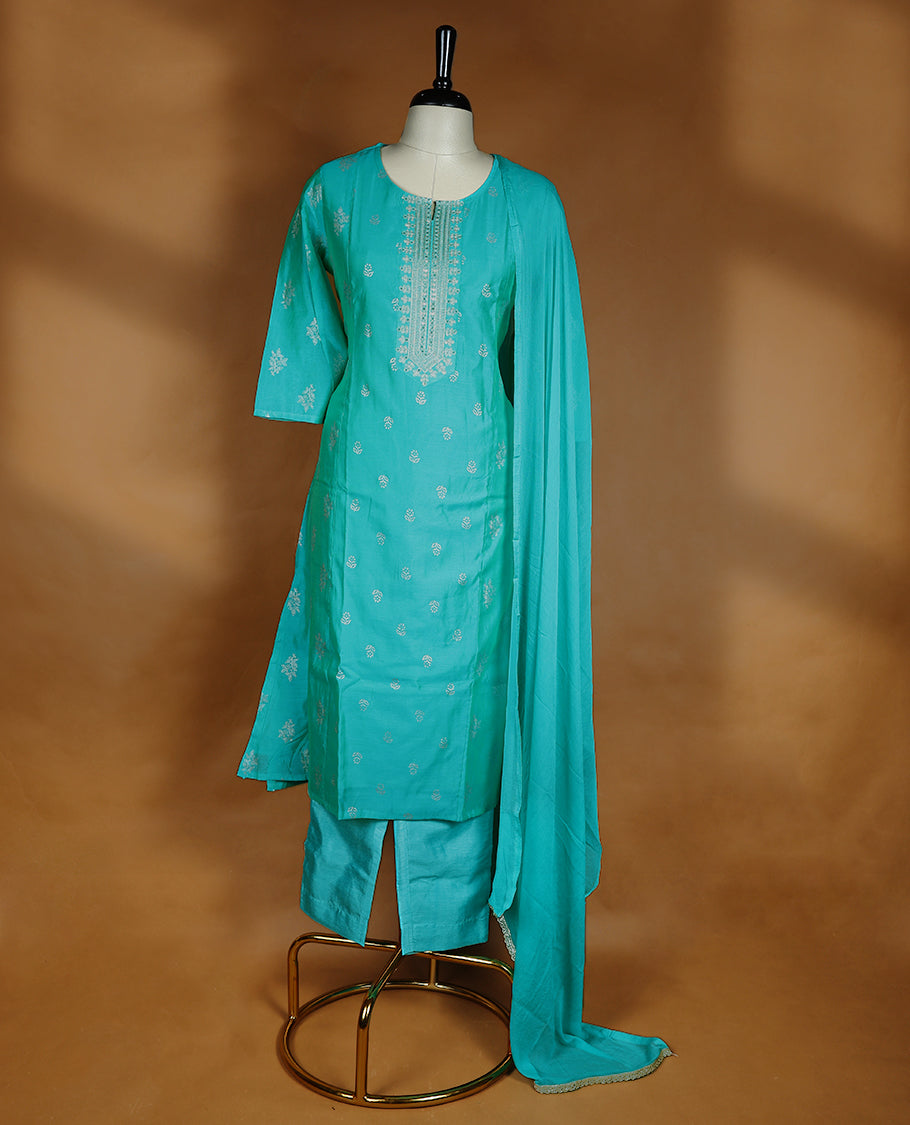 Aqua green colour salwar from TWARA, featuring a round neck adorned with sequins and thread work, with floral prints on the top, paired with a matching bottom and dupatta.