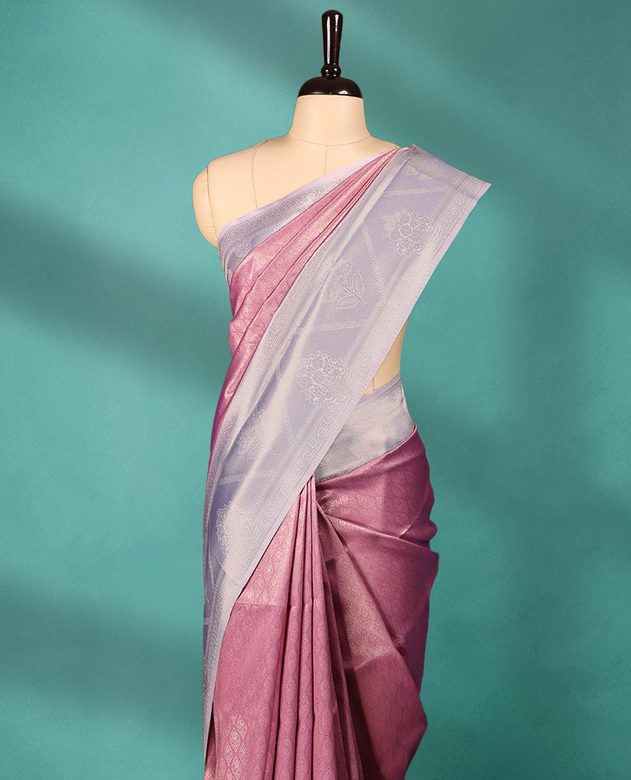 Onion coloured semi silk saree featuring a Brocade body, paired with a Light Pastel Purple coloured border and matching blouse.