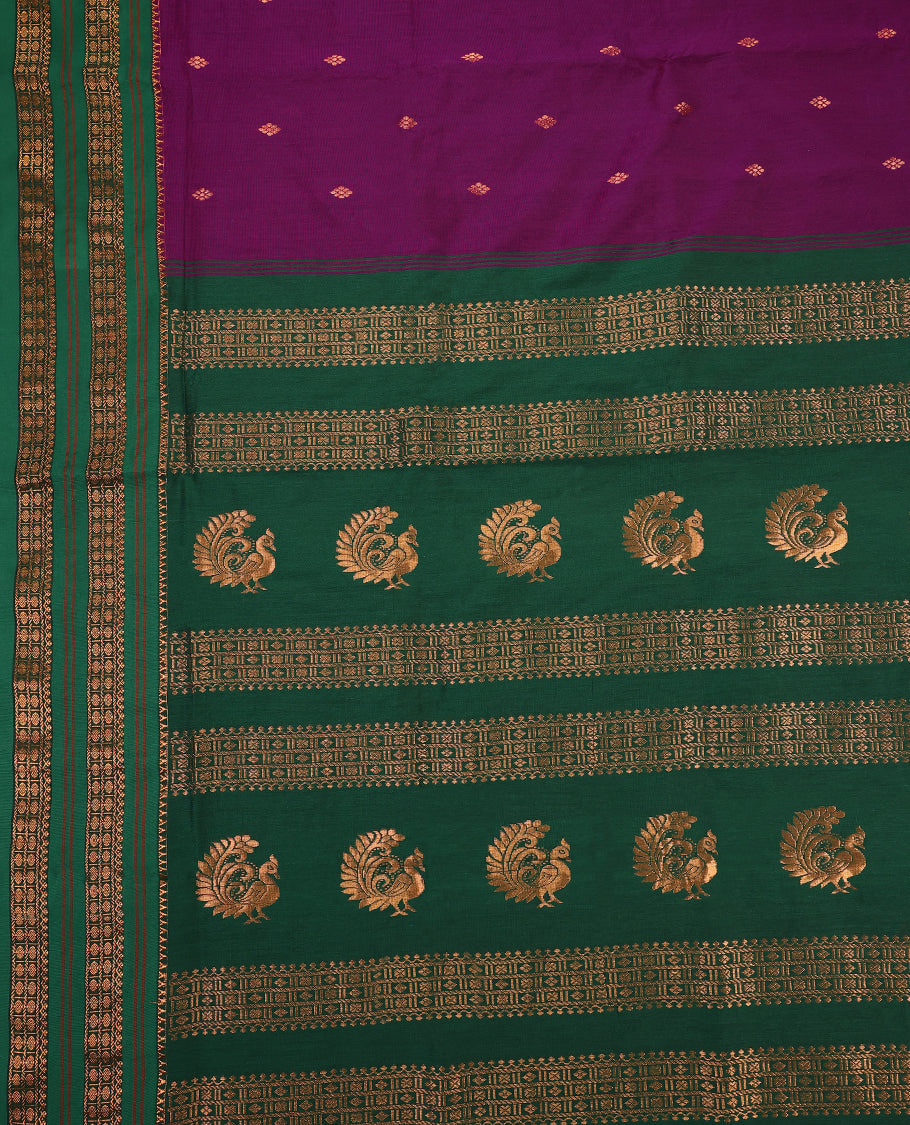 Grape and Green Kalyani cotton saree adorned with delicate buttas across the body, complemented by intricately woven golden zari patterns on the border and pallu, paired with a matching blouse