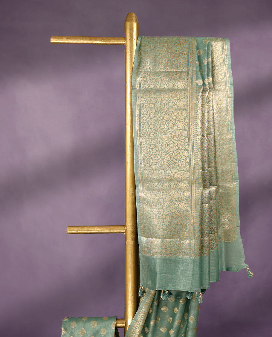 Light Aqua colour pure Banarasi Chanderi cotton, beautifully adorned with traditional antique zari Small Butta designs across the body, completed with a hand-dyed colour, a traditional border, and a matching blouse.