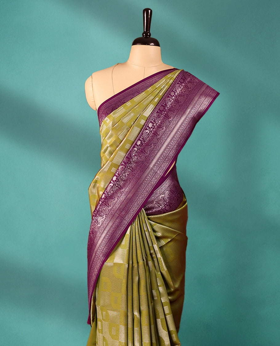 Mung Bean coloured semi silk saree featuring a Silver coloured Zari design on the body, paired with a Grape coloured border and matching blouse.