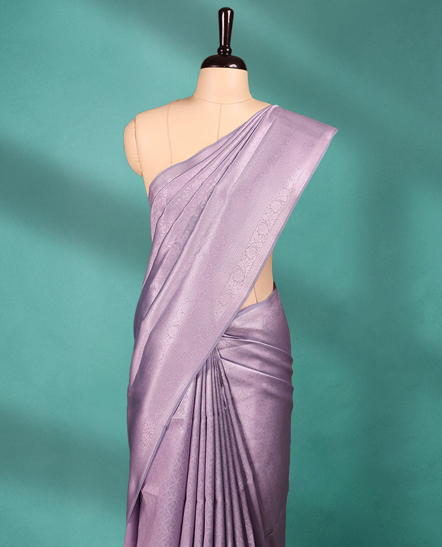 Pastel Purple coloured semi silk saree featuring a Silver coloured Zari Diamond design on the body, paired with a Self coloured border and matching blouse.