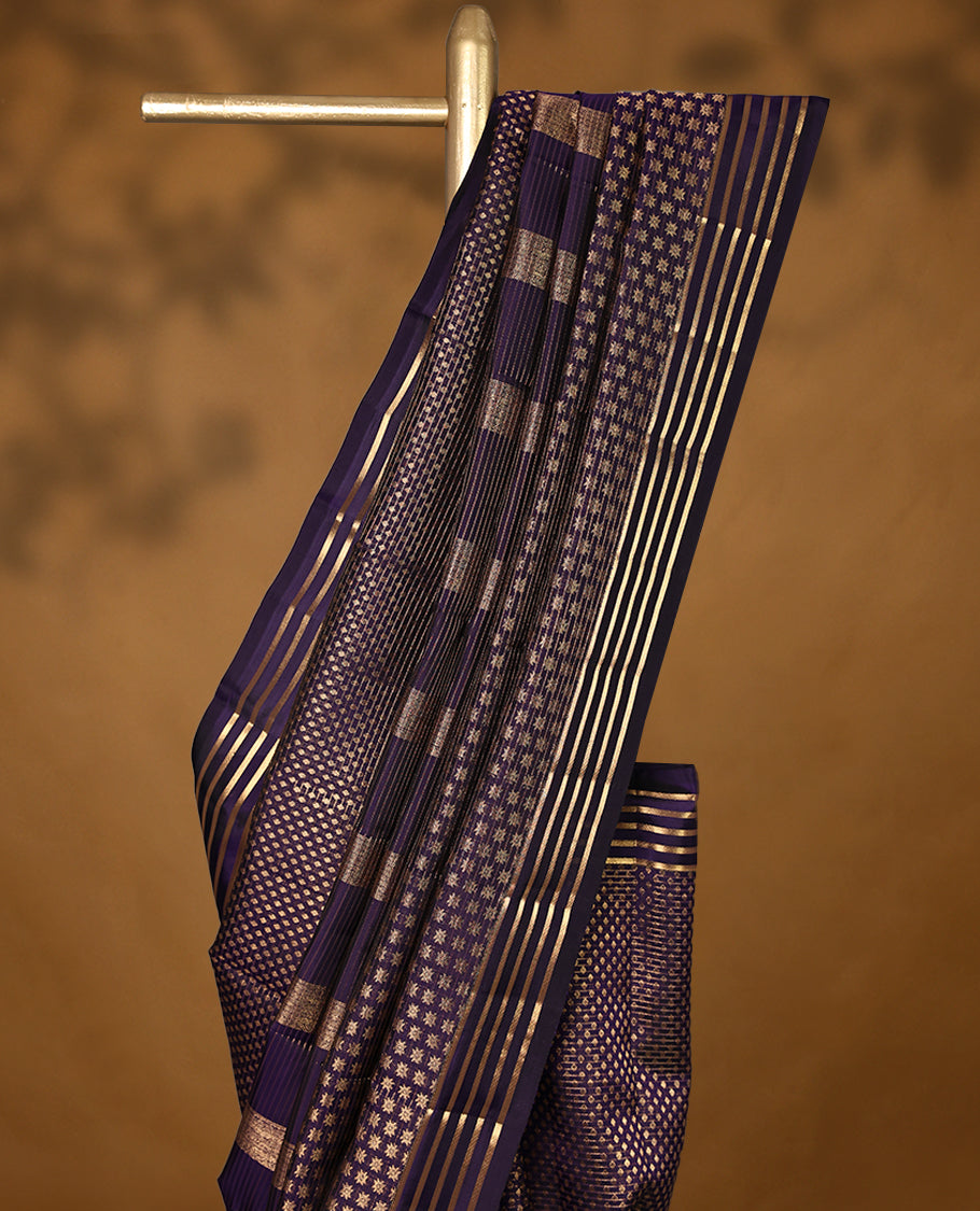 Dark purple Colour soft silk saree adorned with antique zari work, featuring a self-coloured floral border and paired with a matching blouse.
