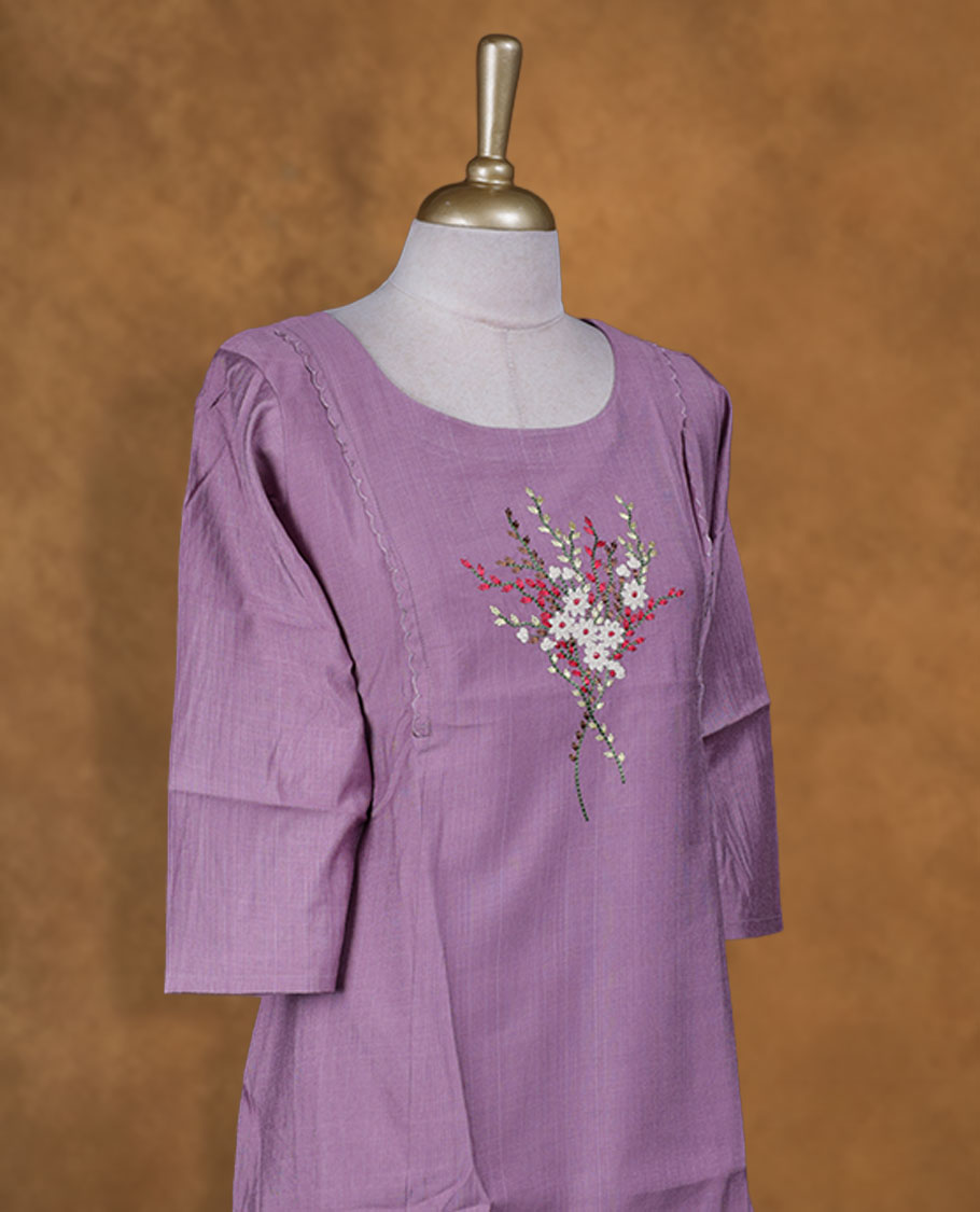 Lavender colour kurti with multicolour floral thread pattern, knee length design, styled with a round neckline and a sleeve .