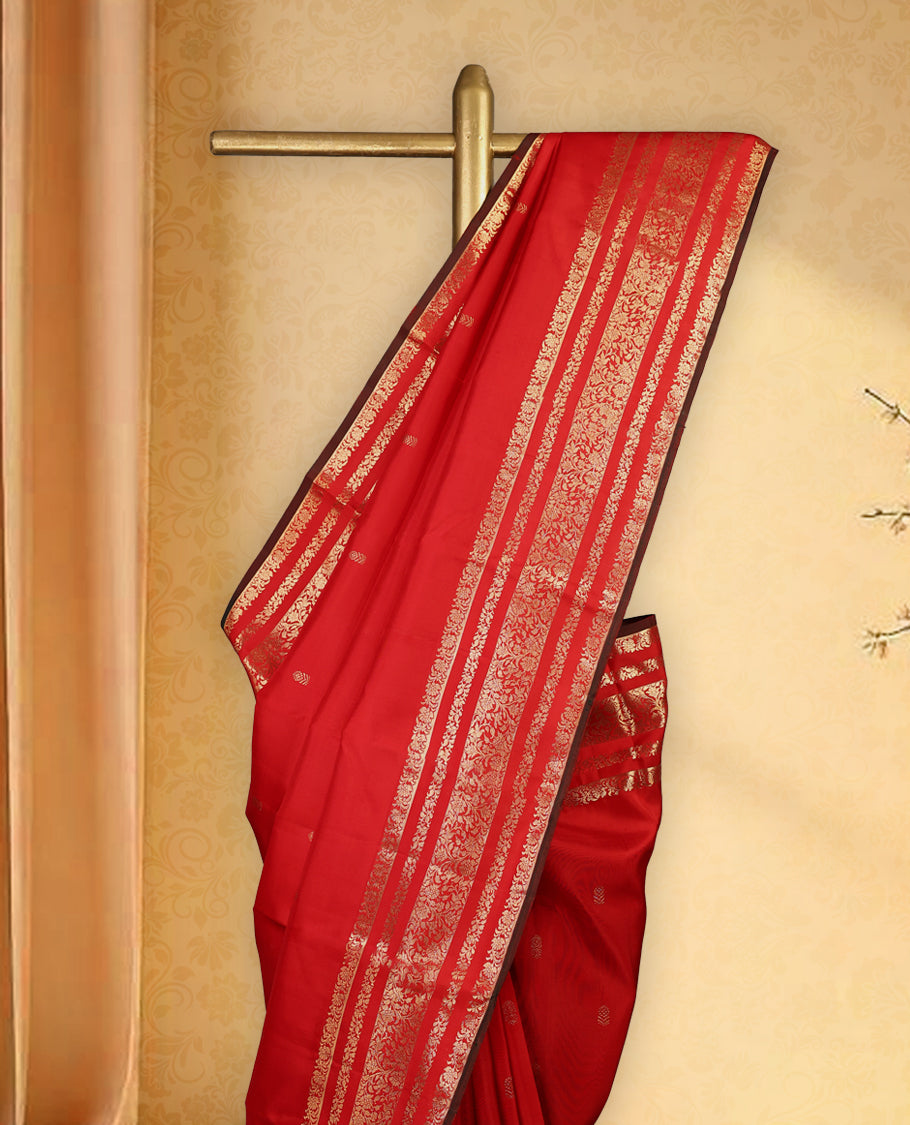 Deep red colour pure Kancheepuram saree with gold zari small floral motifs on the body, traditional border with floral kodi motifs and dark piping grand gold zari woven pallu, paired with contrast matching blouse