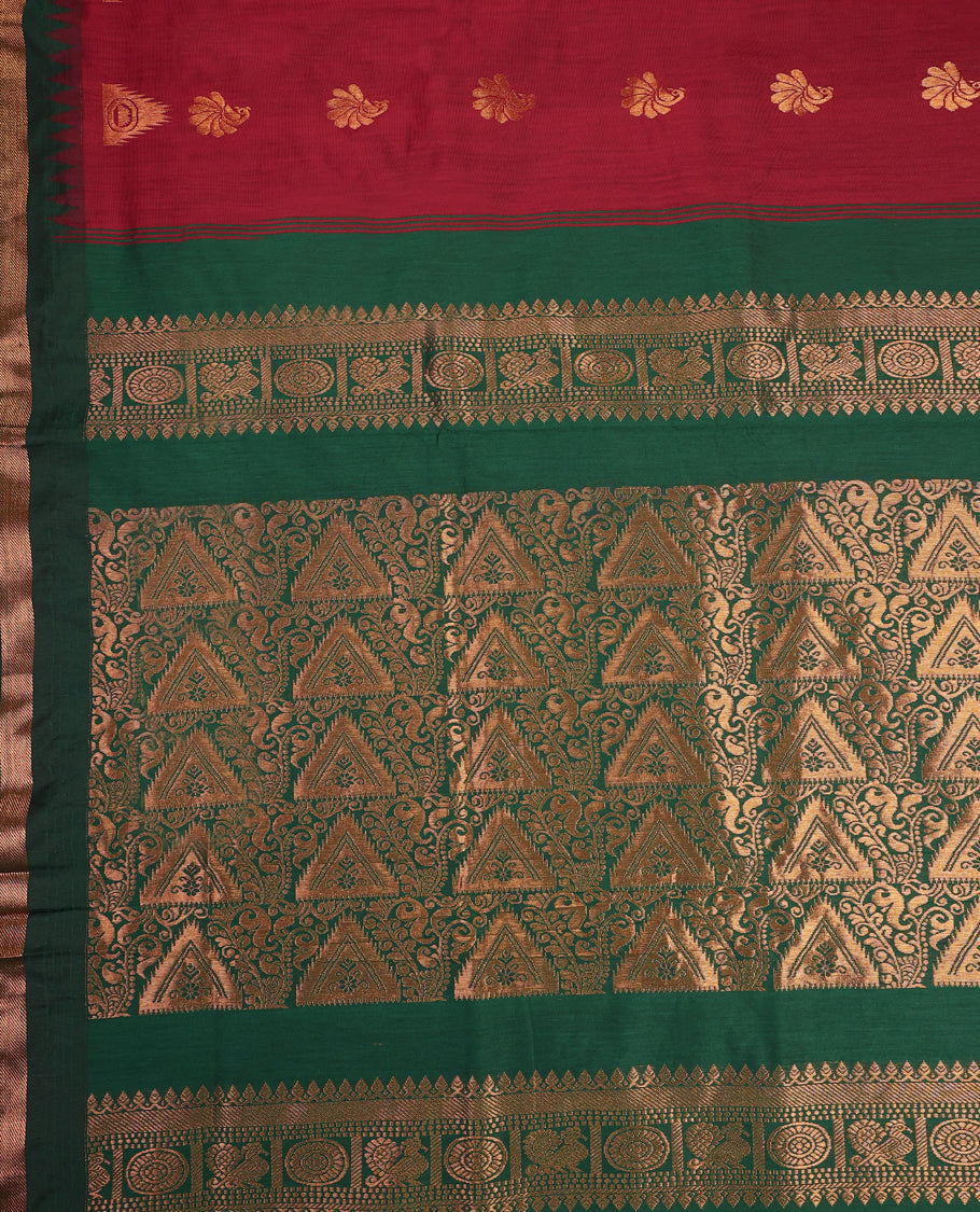 Brick red and Dark Green Kalyani cotton saree featuring delicate golden floral and peacock motifs, highlighted with an intricately woven zari border and pallu, paired with a matching blouse
