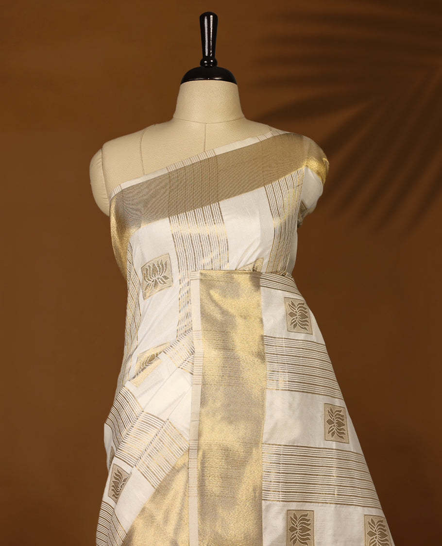 Elegant white colour soft Tussar Kerala saree featuring Stripes and Lotus detailing on body, Gold kasavu border, Rich Pallu, offering a classic and graceful look, paired with a matching blouse.