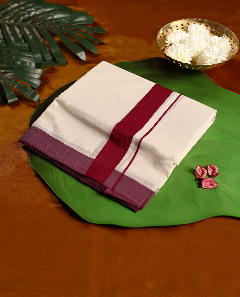 Off white colour cotton double dhoti featuring a striking maroon kara with subtle edging, crafted for traditional grace and everyday comfort, perfect for cultural gatherings and festive occasions.