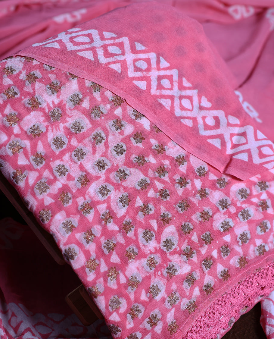 Pink colour churidhar material adorned with gold and copper toned floral patterns and bold block designs, paired with a plain matching bottom & Comes with a floral flowery printed dupatta.