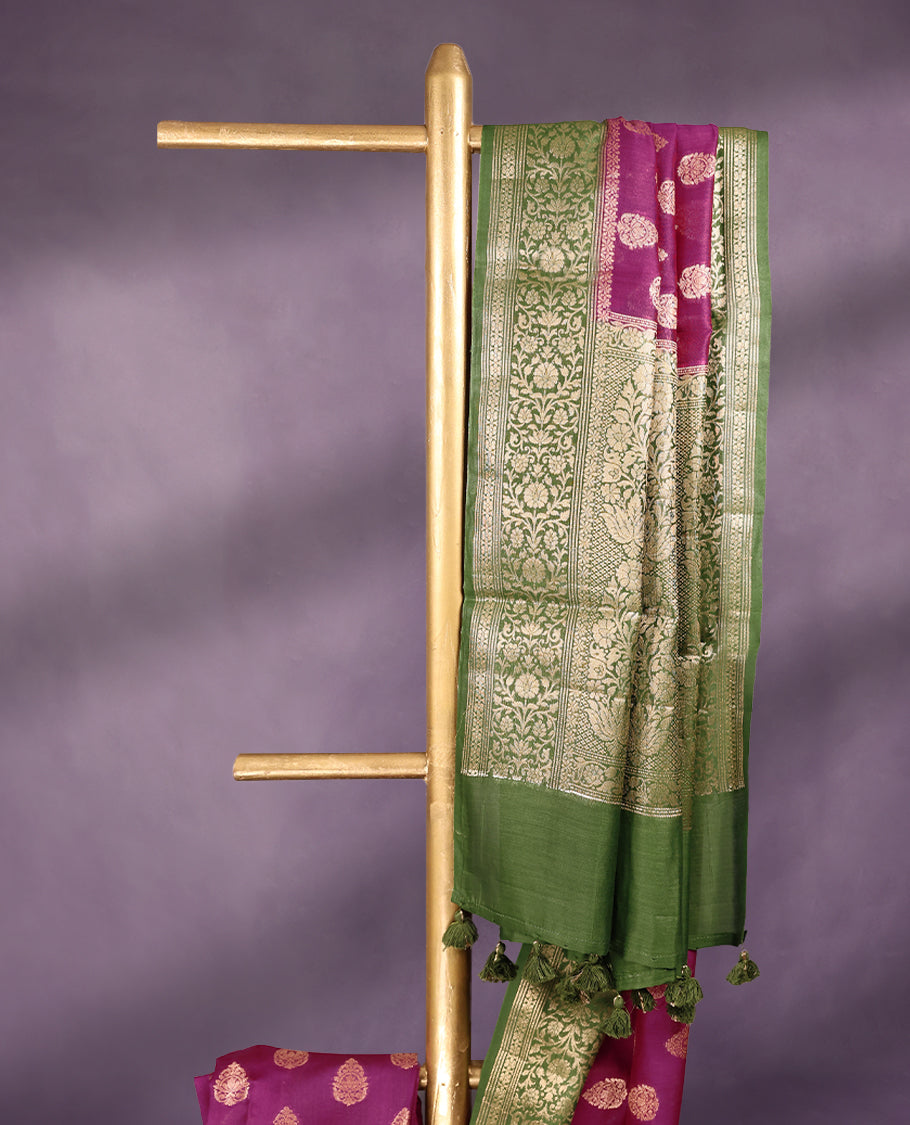 Rani colour pure Banarasi Chanderi cotton fabric, featuring traditional antique zari buttas on the body, complemented by a traditional Green Colour border and a matching blouse.
