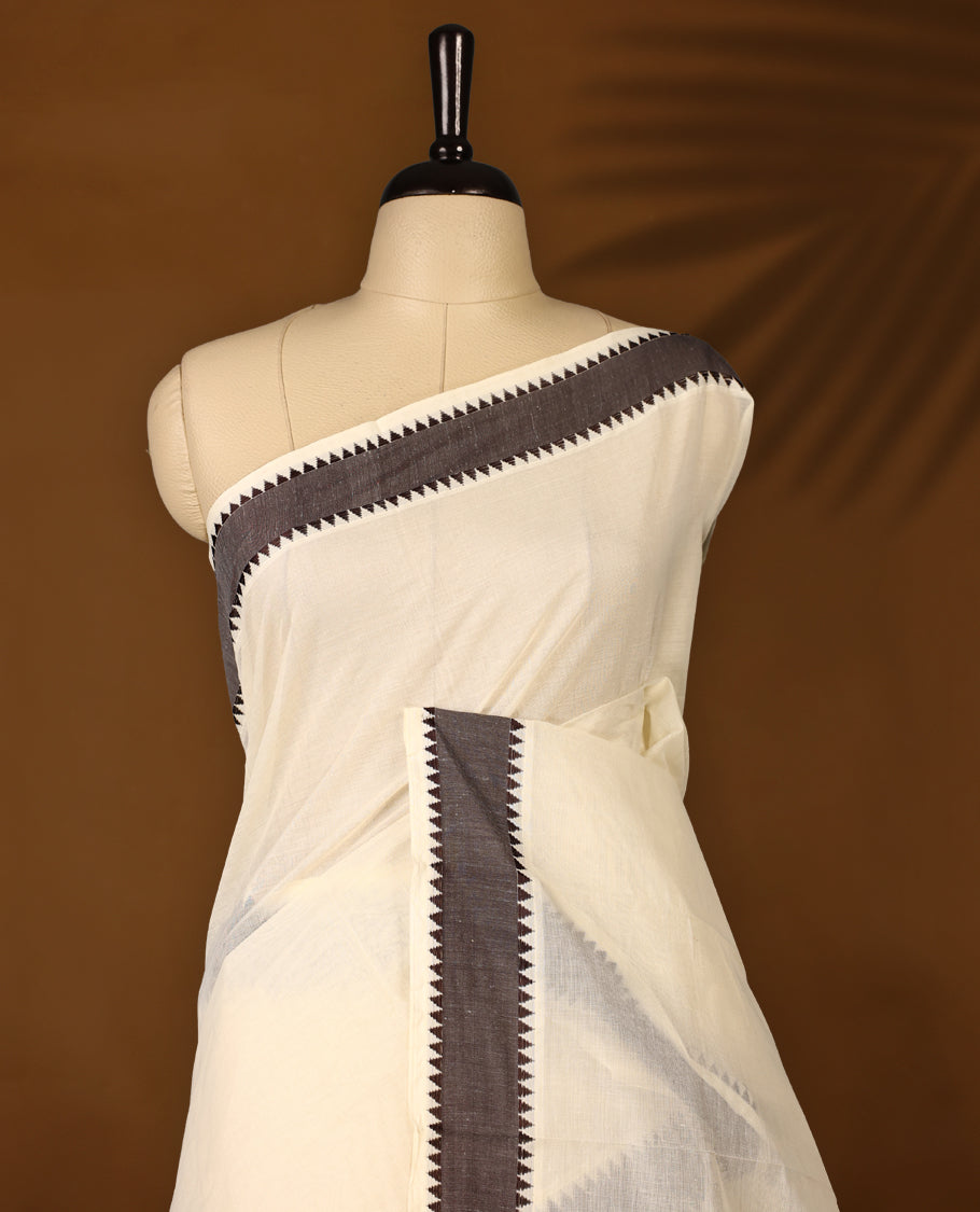 Elegant off white colour cotton Kerala saree featuring Plain body, Dark Chocolate colour border with Peacock Motifs, Paired with matching blouse offering a classic and graceful look, paired with a matching blouse.