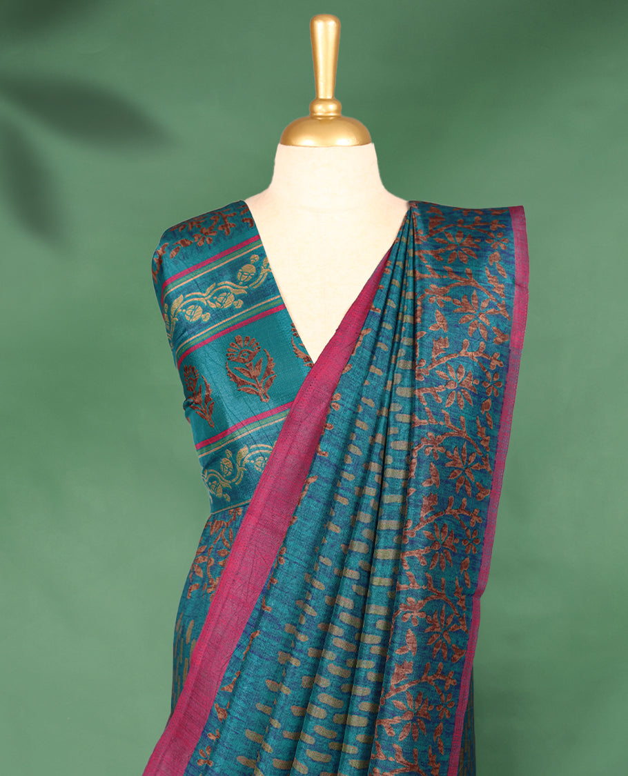 Light Blue Colour Manipuri saree features a brick patterned body in olive hues, beautifully offset by a contrasting magenta border with copper floral-printed, and comes with a matching blouse.