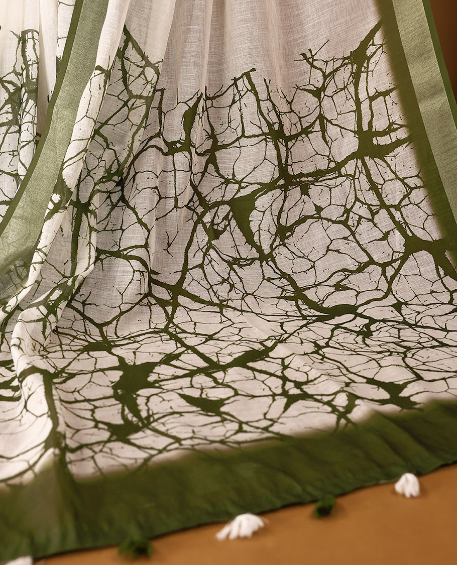 White cotton saree adorned with green abstract patterns and a rich green border with Matching Blouse