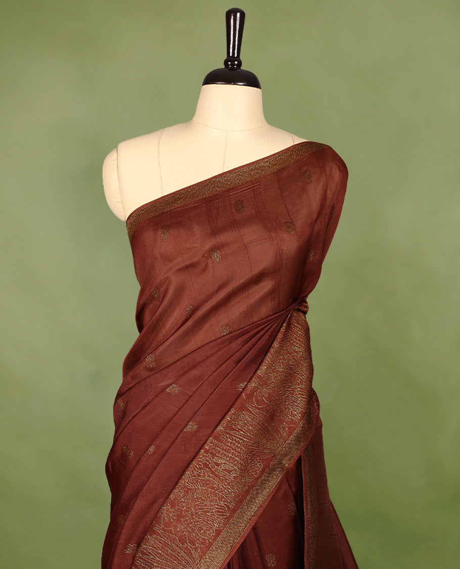 Rust Orange semi-Banaras tussar georgette saree adorned with antique zari floral motifs on the body, beautifully highlighted with a pencil art garden-inspired border, paired with a matching blouse.