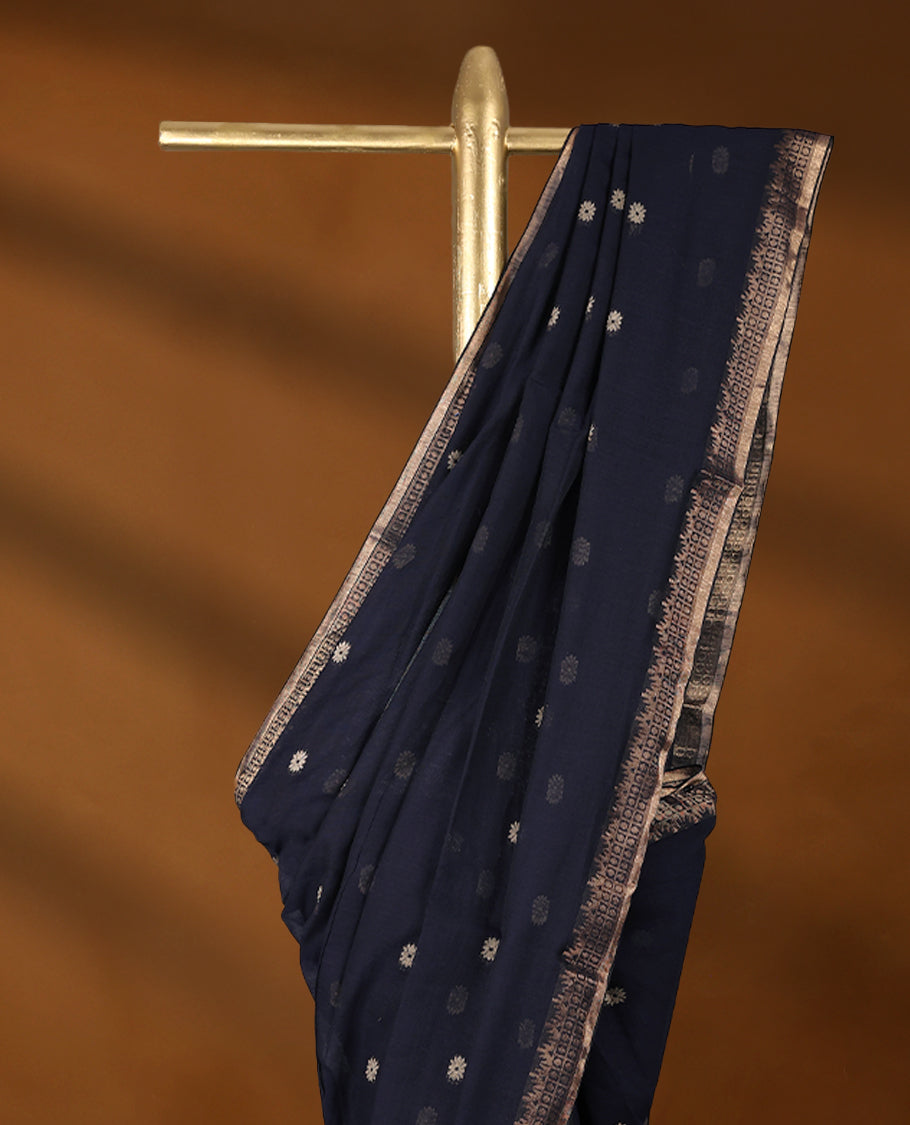 Deep Navy blue colour soft khadi cotton saree with small Beige Zari Flower motifs on the body, detailed woven Gold zari border, paired pallu with tussles, with matching blouse.