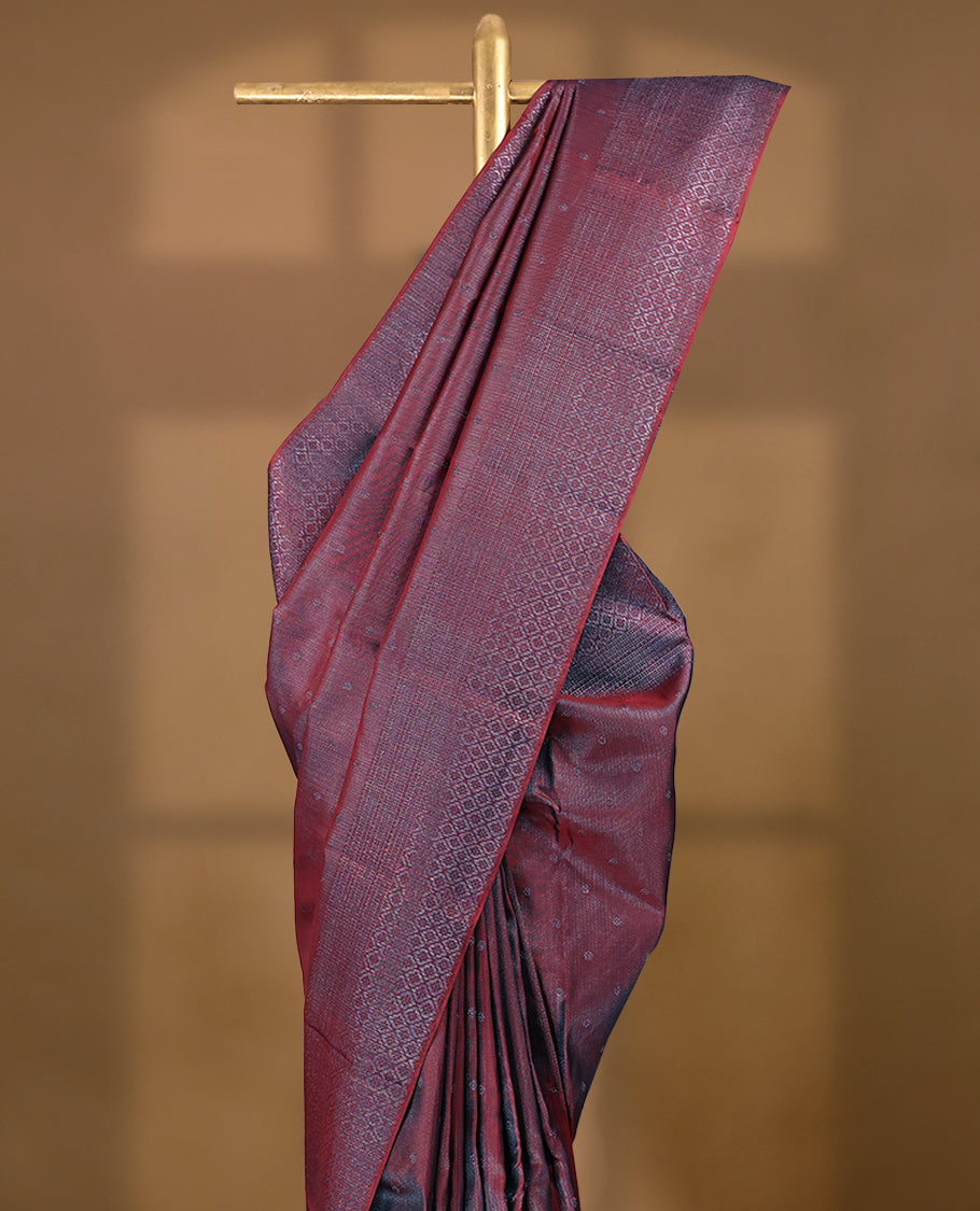 Maroon coloured Manthrakodi saree featuring a multicoloured zari jacquard body, complemented by a self coloured turning Banarasi border and a matching self coloured blouse.