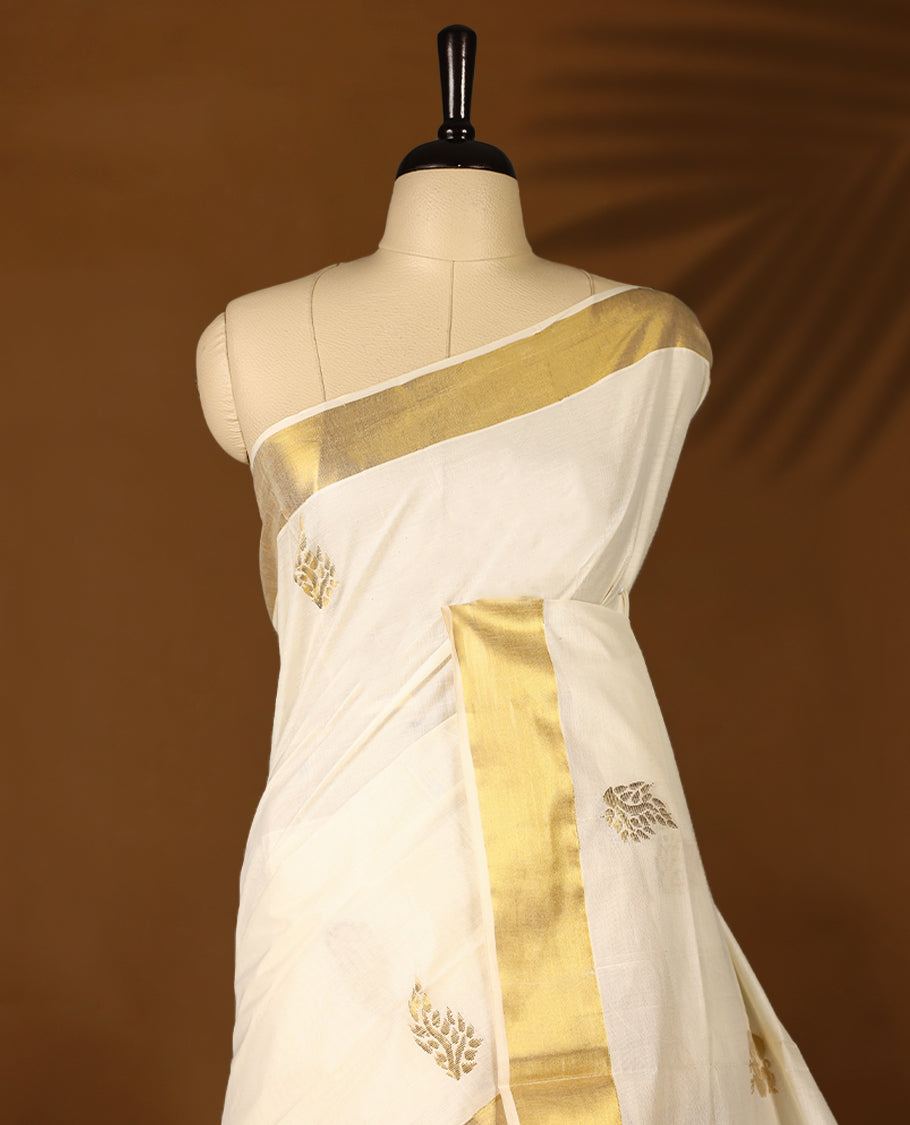 Elegant off white colour cotton Kerala saree featuring Gold zari Floral motifs on body, traditional golden zari kasavu border & Rich Pallu offering a classic and graceful look, paired with a matching blouse.