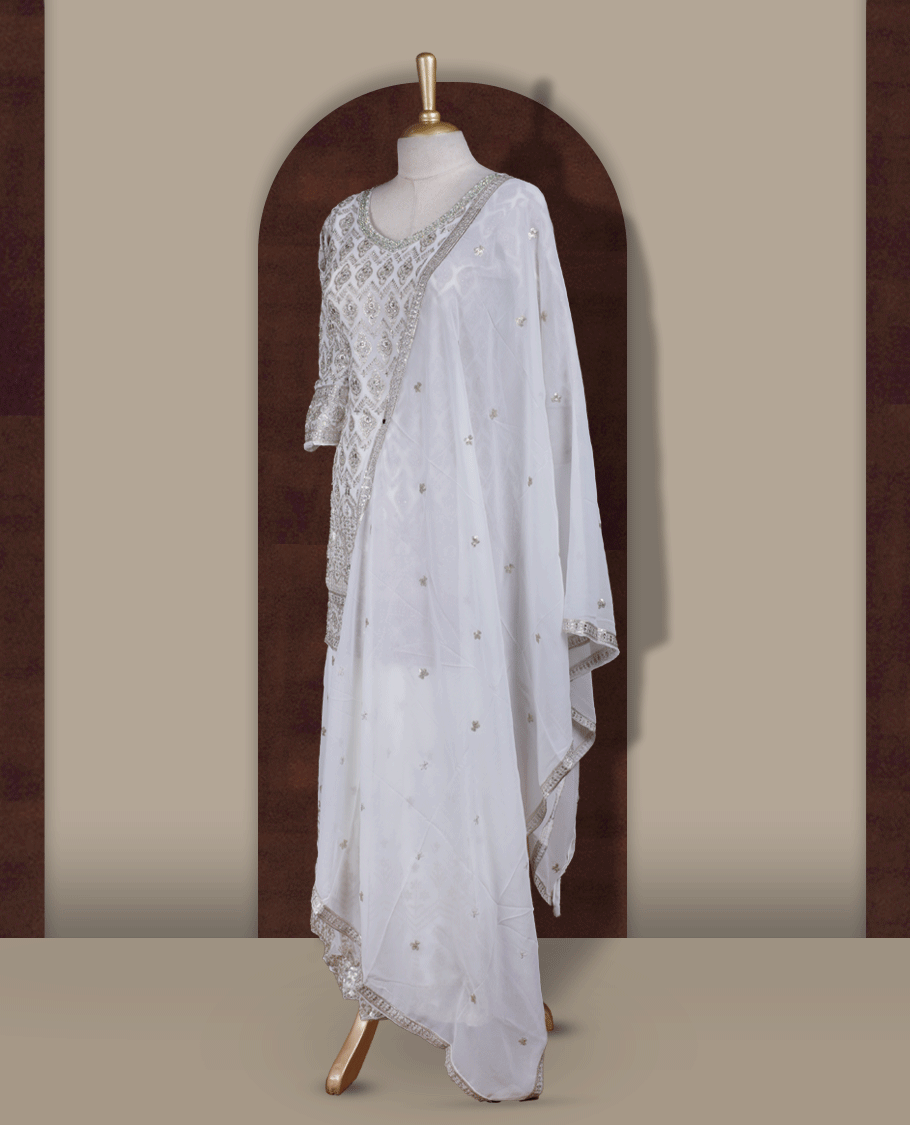 Elegant Off white colour embroidered sharara set featuring intricate copper toned thread work and delicate stones & sequin detailing, paired with a graceful off white dupatta adorned with subtle motifs and a beautifully flared embroidered bottom.