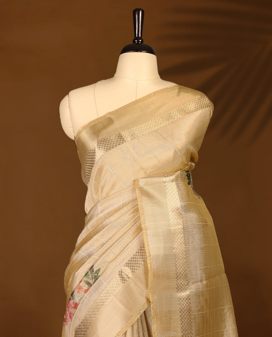 Light gold colour organza Kerala saree featuring subtle checkered weave with zari detailing on the border and pallu, highlighted with delicate floral accents near the pleats, paired with a matching blouse.