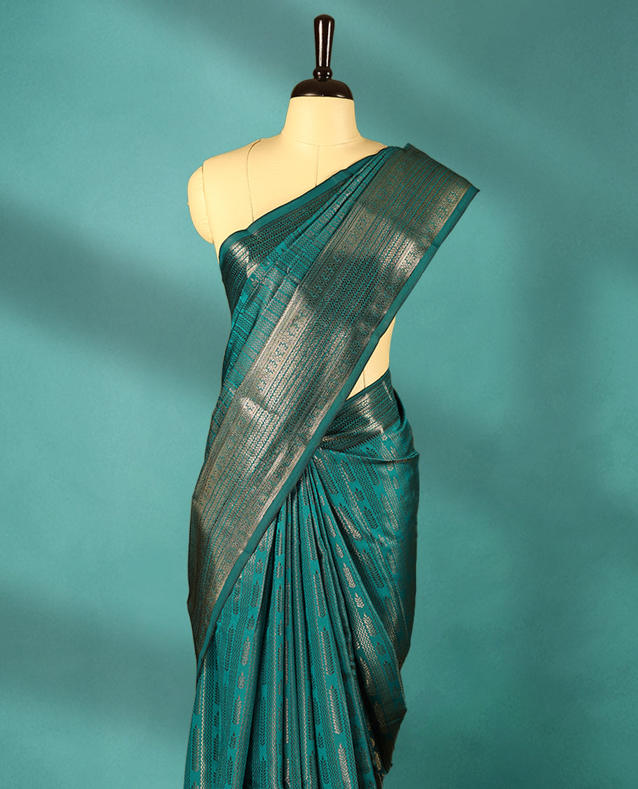 Teal Green Art Soft Silk Saree showcases intricate silver zari work on the body and border, paired with a matching blouse
