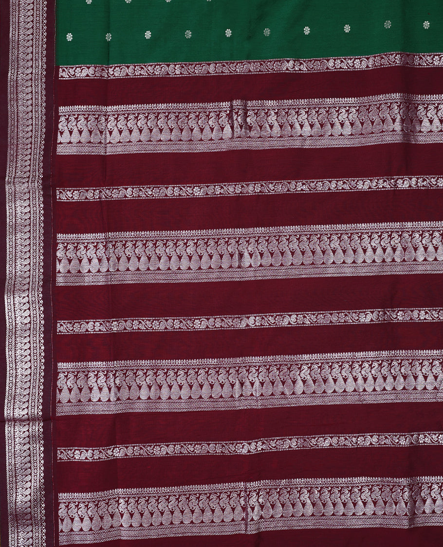 Bottle Green colour mixed Kalyani cotton saree featuring Silver zari flower motifs throughout the body, paired with a Maroon colour traditional border and pallu, with matching blouse