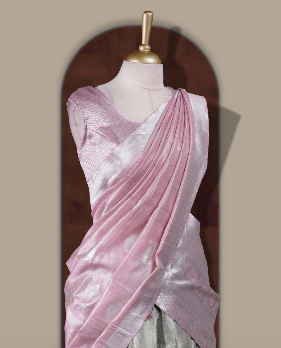 Light green and pink colour Dhavani set featuring a Light green colour skirt with contrast Pink colour border with rich silver zari pattern, paired with a contrasting Pink dupatta detailed with silver motifs