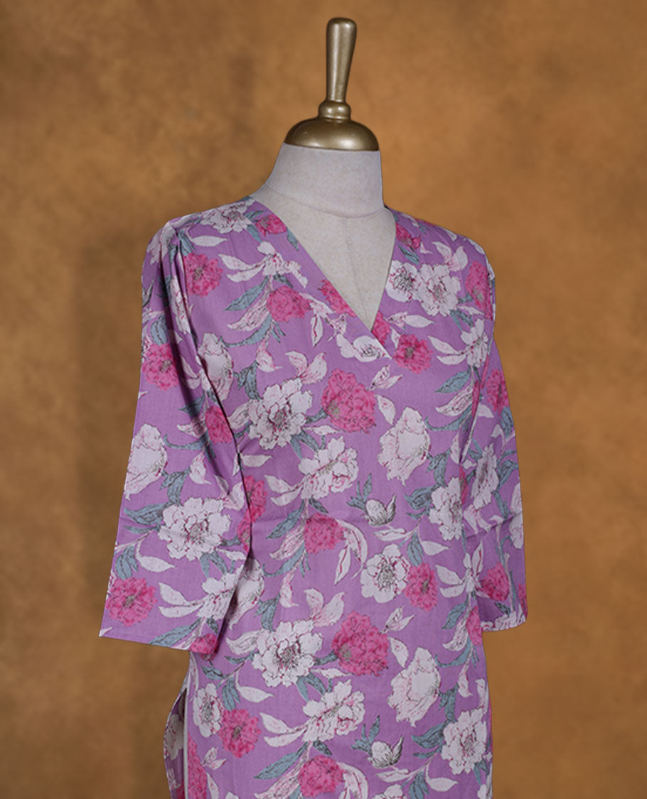 Light purple colour kurti enlivened with white and fuchsia floral blooms, styled with a graceful V-neckline and easy 3/4th sleeves.