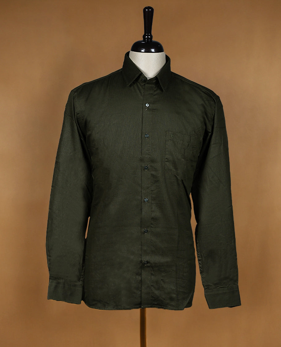 Deep olive green colour OTTO men's shirt in a relaxed formal fit, featuring a subtle self design pattern, classic collar, full sleeves, and a front chest pocket ideal for work or smart casual wear.
