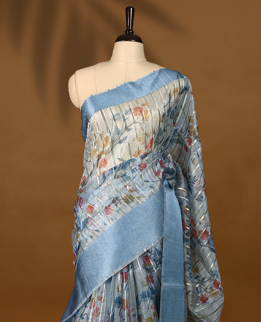 Blue semi-organza saree with intricate floral jaal work, elegant border, and a matching silk brocade blouse.