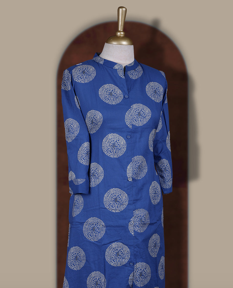 Brick blue colour cotton cord set featuring a straight kurta with a mandarin collar, front buttons, and three quarter sleeves & adorned with white circular block prints and paired with matching palazzo pants.