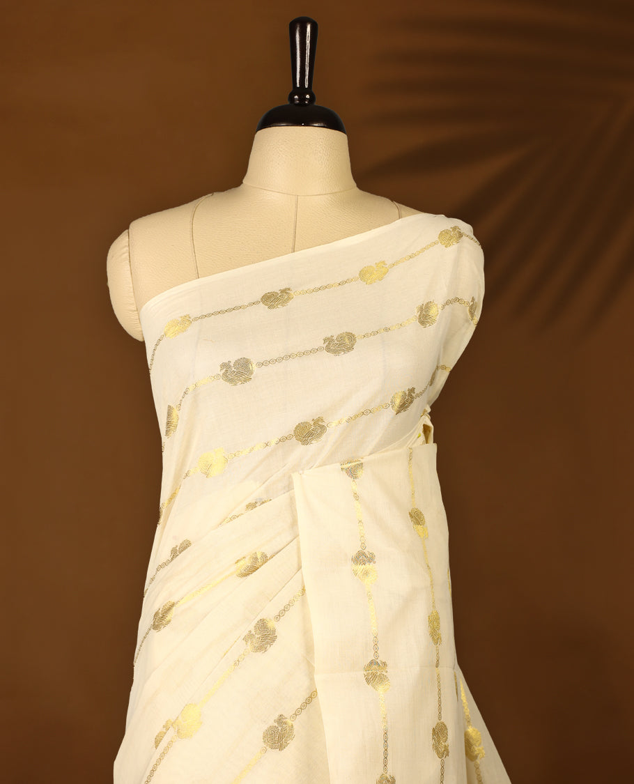 Elegant off white colour cotton Kerala saree featuring a gold Zari stripes with peacock motifs on body, with Red colour tassels offering a classic and graceful look, paired with a matching blouse.