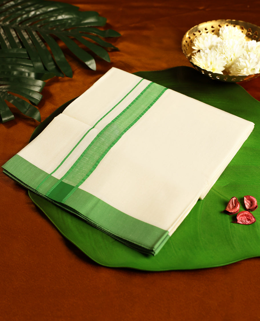 Off white colour cotton single dhoti featuring a light green kara with fine double line edging, crafted for traditional elegance and daily comfort, perfect for rituals, temple visits, and cultural occasions.
