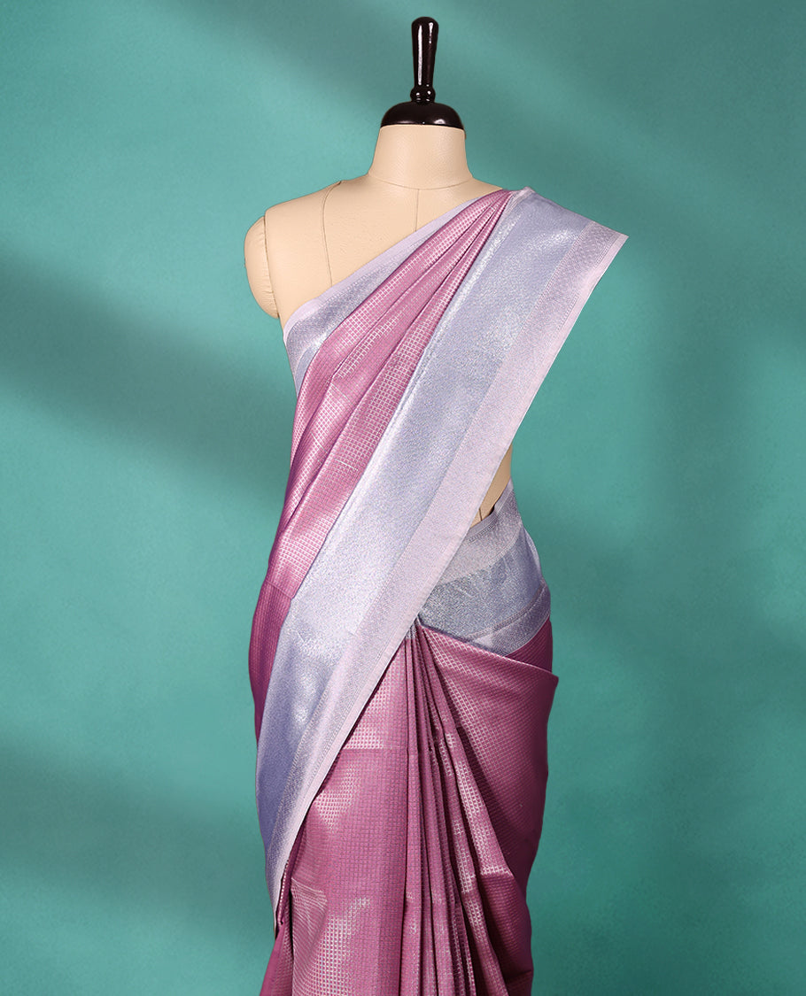 Pastel Onion coloured semi silk saree featuring a Check design on the body, paired with a Baby Blue coloured border and matching blouse.
