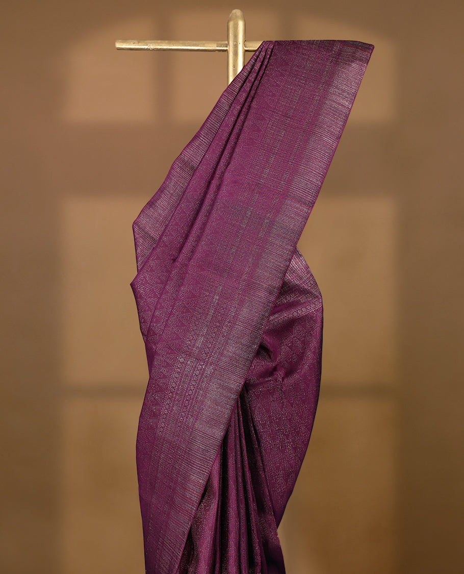 Grape coloured Manthrakodi saree featuring a multicoloured zari jacquard body, complemented by a self coloured turning Banarasi border and a matching self coloured blouse.
