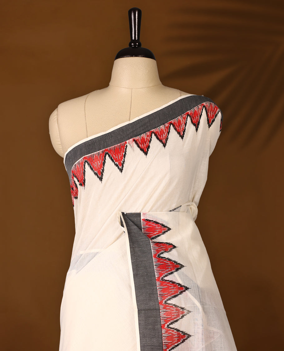 Elegant off white colour cotton Kerala saree featuring Plain body, Black colour border with red Colour temple designs, Paired with matching blouse offering a classic and graceful look, paired with a matching blouse.