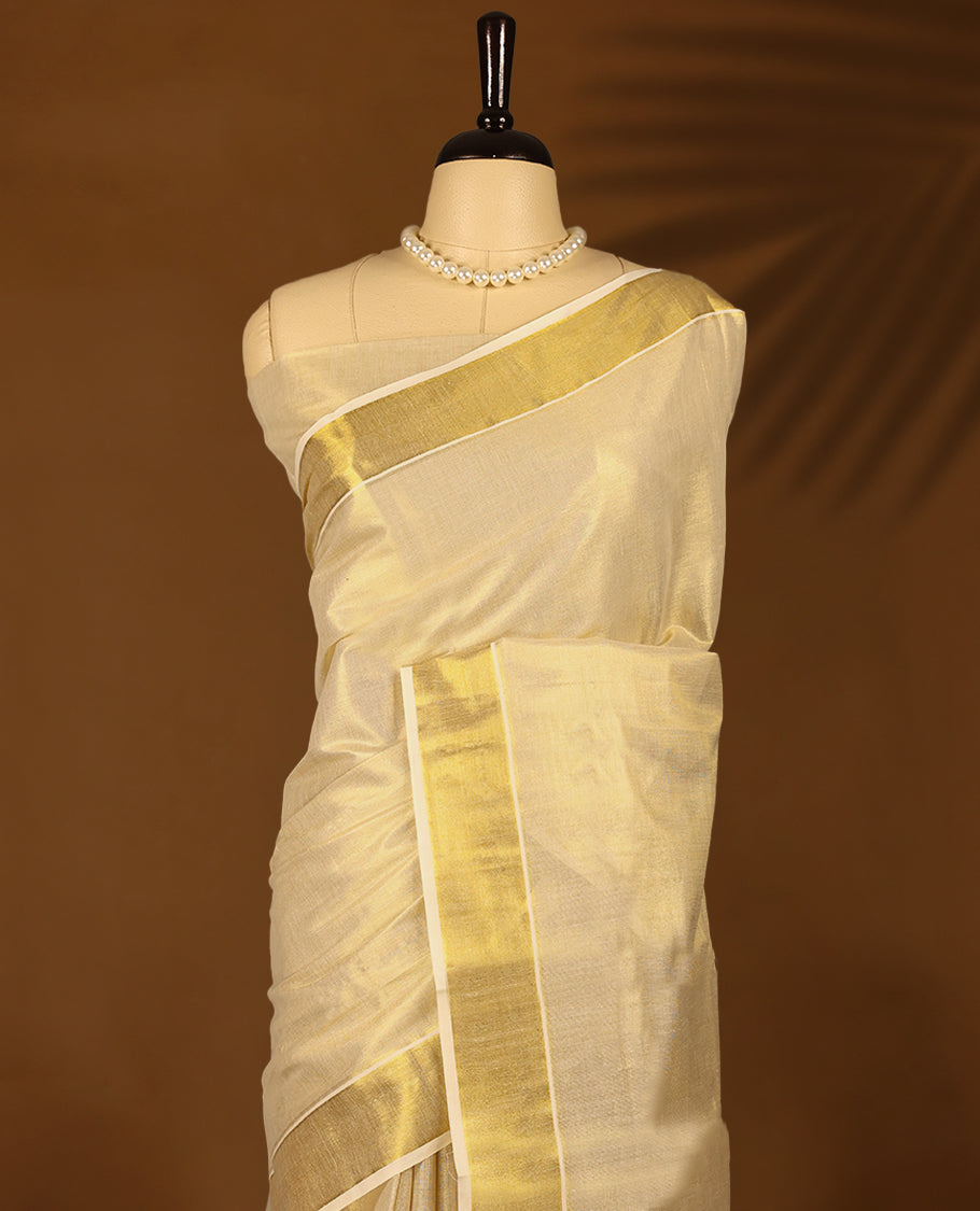 Kerala tissue saree, beautifully accented with a lustrous golden border having subtle temple motifs with Matching Blouse.