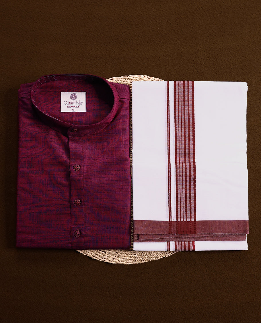 RAMRAJ maroon kurtha paired with a white dhoti, elegantly finished with a matching maroon border.