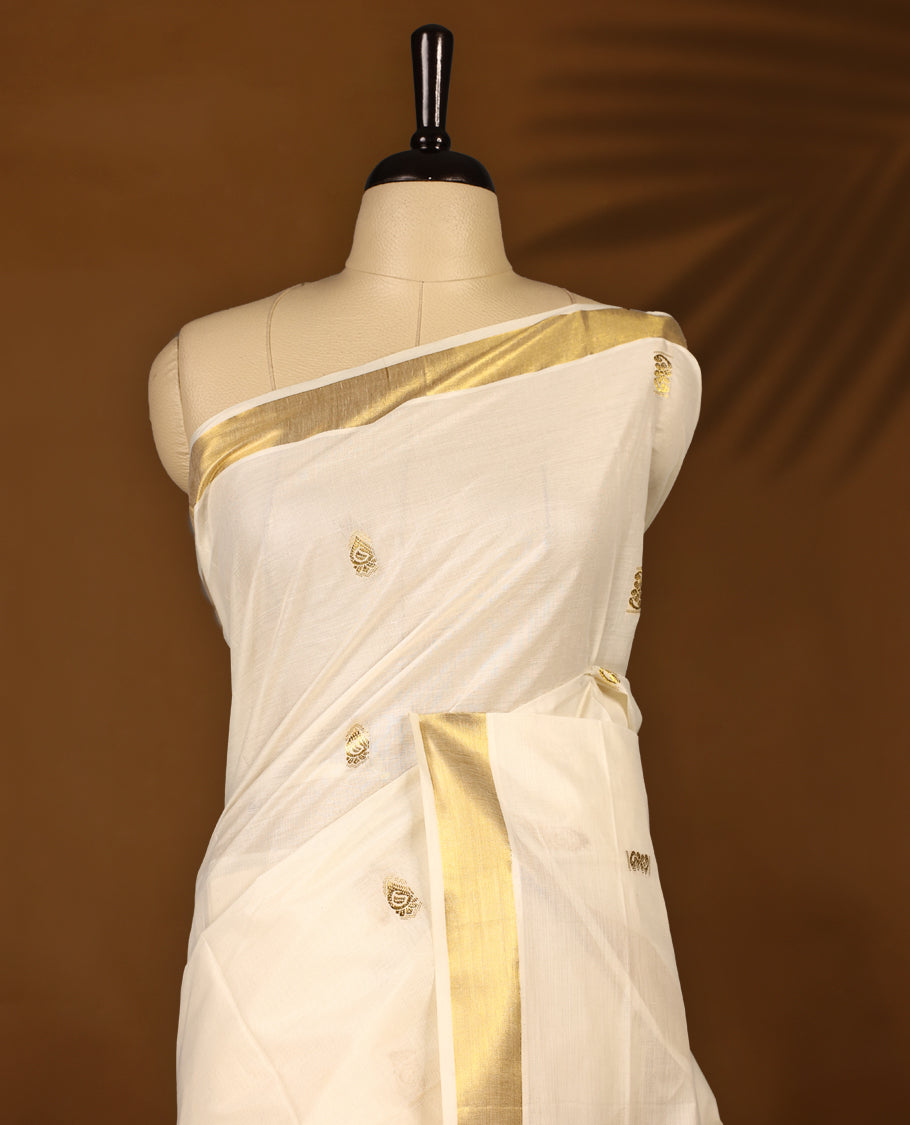 Elegant off white colour cotton Kerala saree featuring Gold zari motifs on body, traditional golden zari kasavu border & Rich Pallu offering a classic and graceful look, paired with a matching blouse.