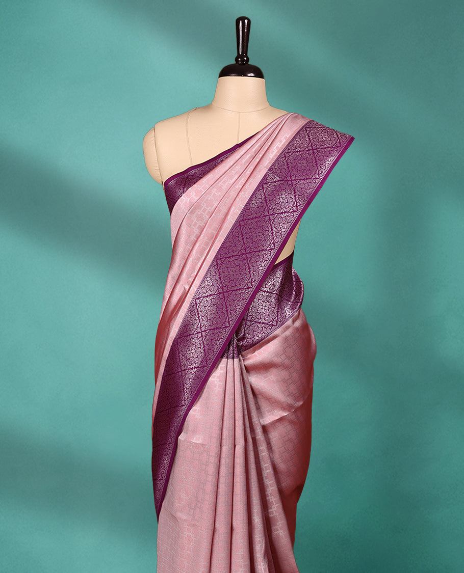 Light Pastel Onion coloured semi silk saree featuring a Zari design on the body, paired with a Grape coloured border and matching blouse.