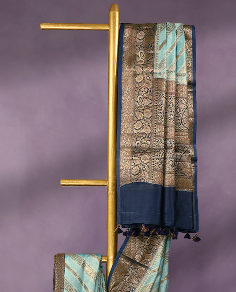 Sky Blue colour pure Banarasi Chanderi cotton, exquisitely detailed with traditional antique zari Aada designs across the body, finished with a hand-dyed contrast traditional border and a matching blouse.