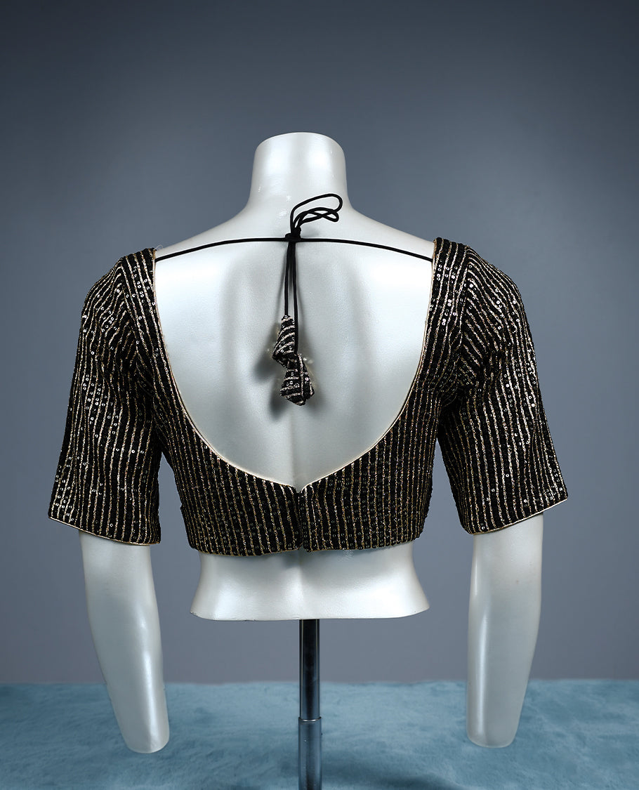 Black designer padded readymad blouse blouse with scoop neckline and elbow length sleeves, embellished with vertical and geometric lines of golden sequins perfect for party or festive wear.
