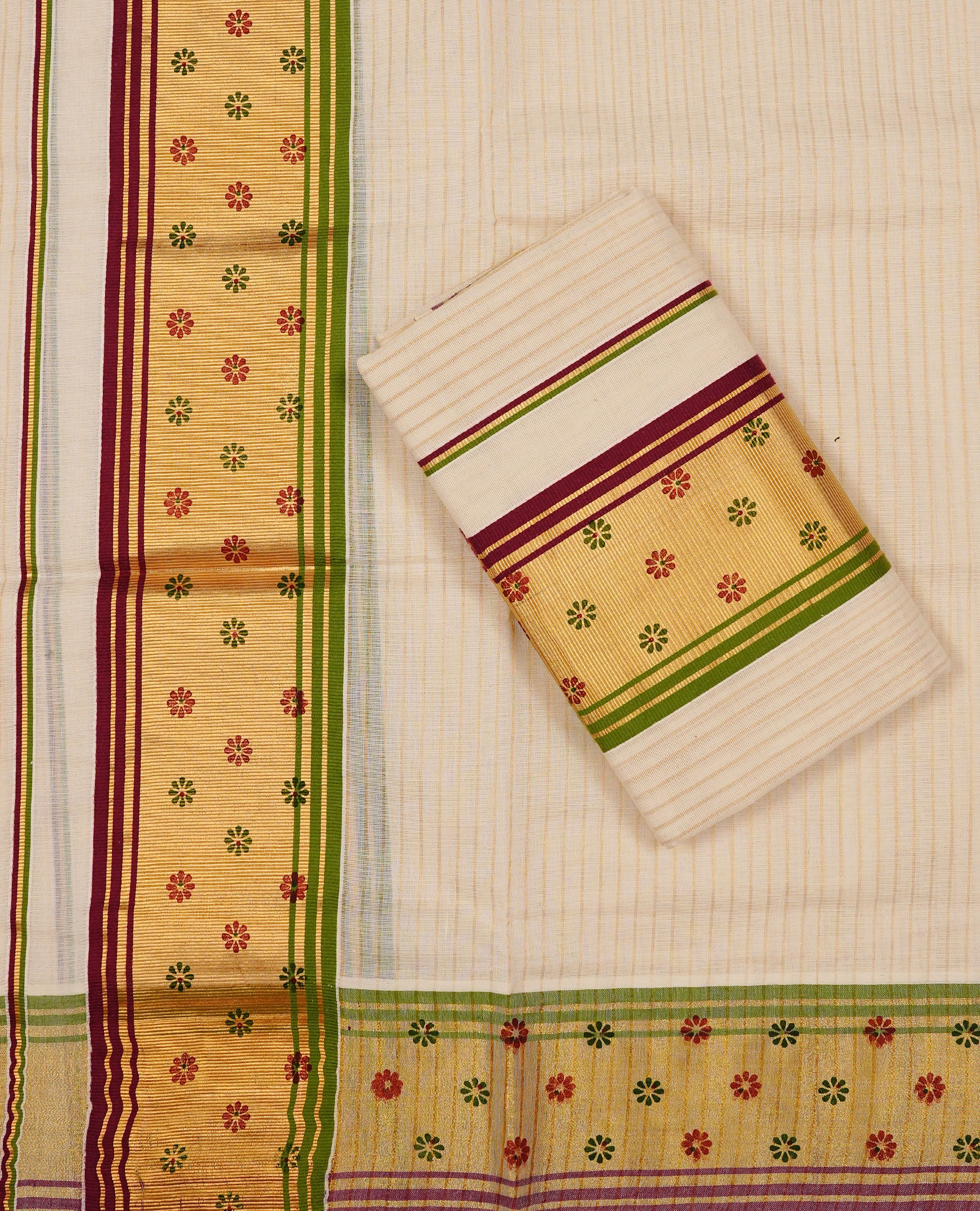 Off white colour Cotton Set Mund featuring a Stripes on body, enhanced by a Green & maroon colour with floral print on zari border.