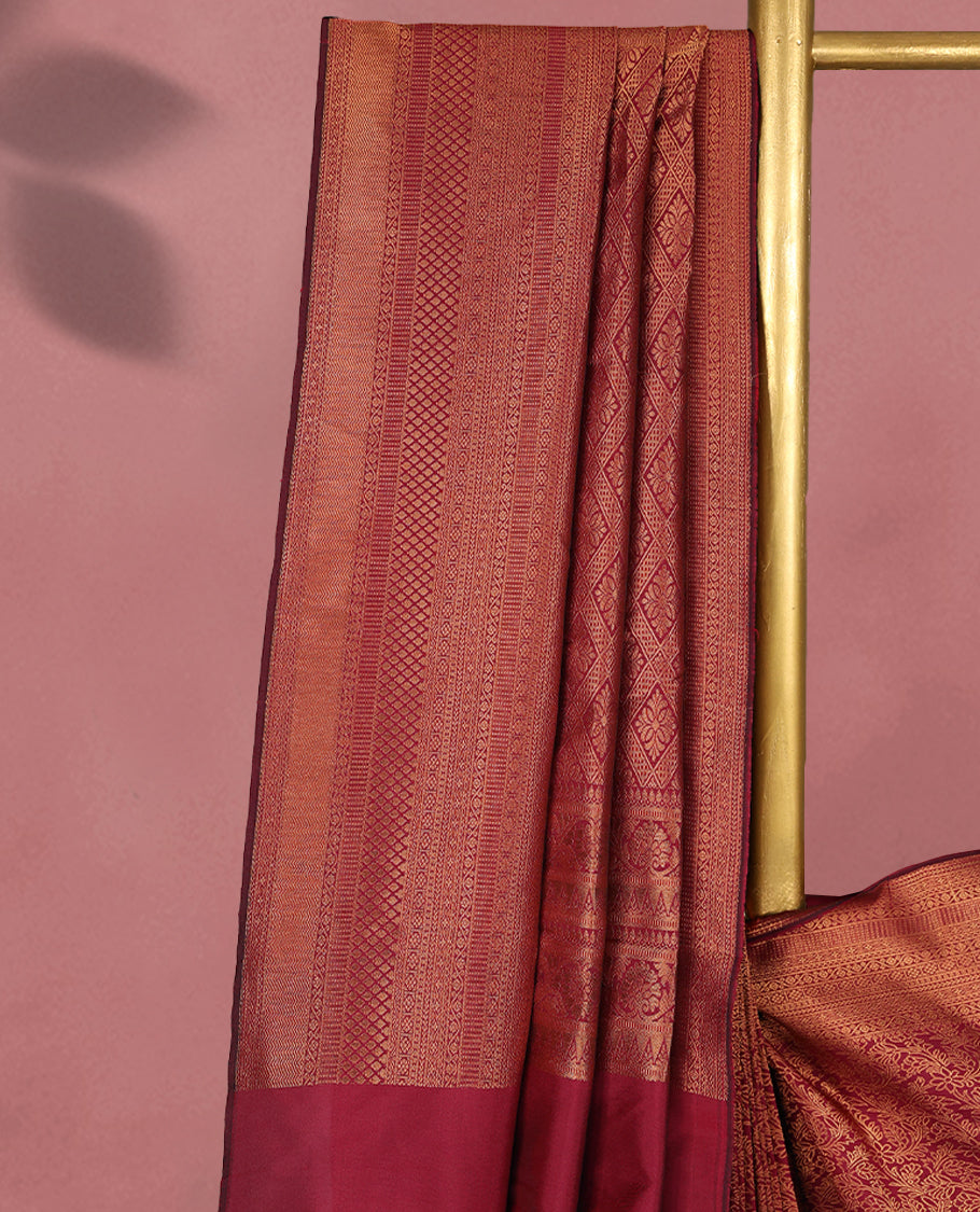 Maroon colour Kancheepuram saree featuring an antique zari brocade body, complemented by a traditional border and a matching blouse.