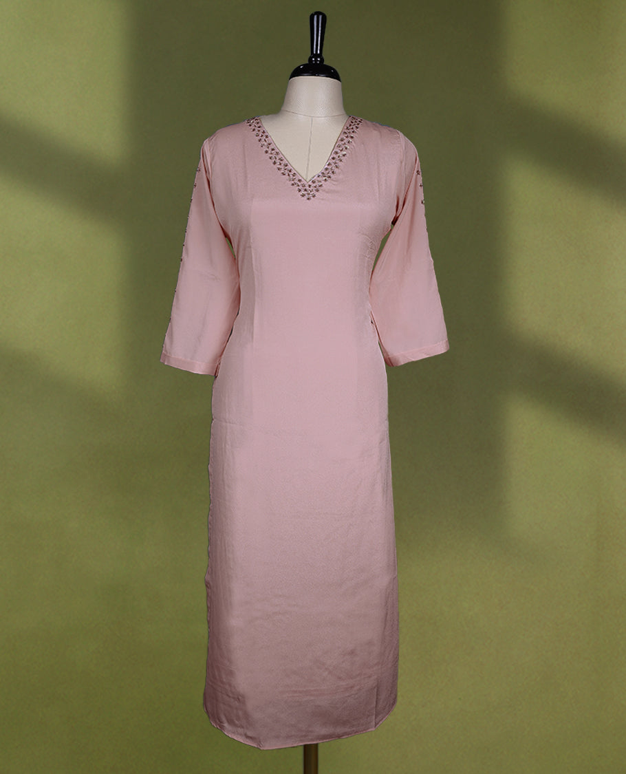 Baby pink coloured stylish kurti with slit, featuring a V neck design adorned with cut beads and sequin work, for women