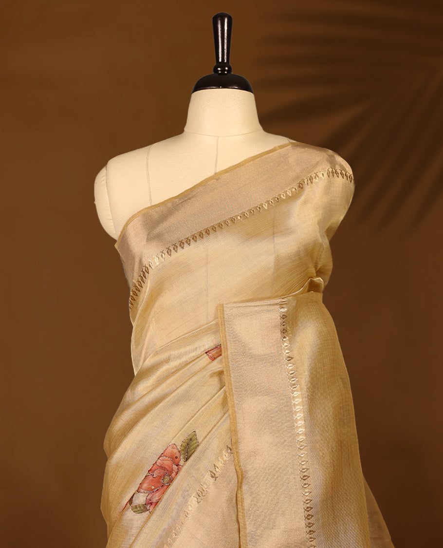 Light gold colour Organza Kerala saree with a sheer, smooth body and soft golden sheen. Accented with a fine zari border and subtle floral motifs near the pleats, Comes paired with a coordinated matching blouse.